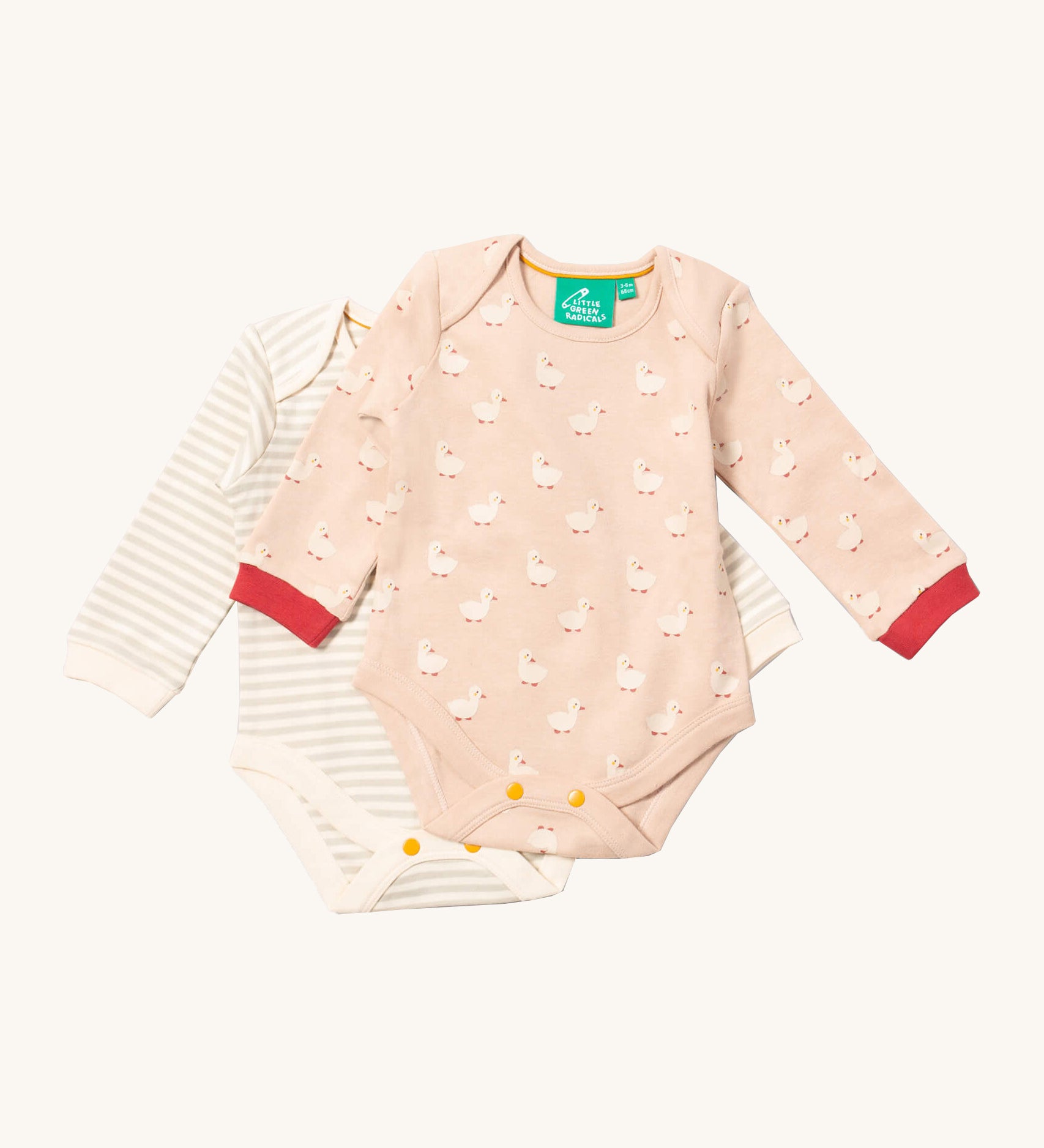 Little Green Radicals puddle ducks baby body suit 2 pack available at Babipur. A soft GOTS organic cotton bodysuit 2 pack in light pink with a cute duck print with red trim and a grey and cream striped bodysuit. Features yellow popper fastener around the crotch