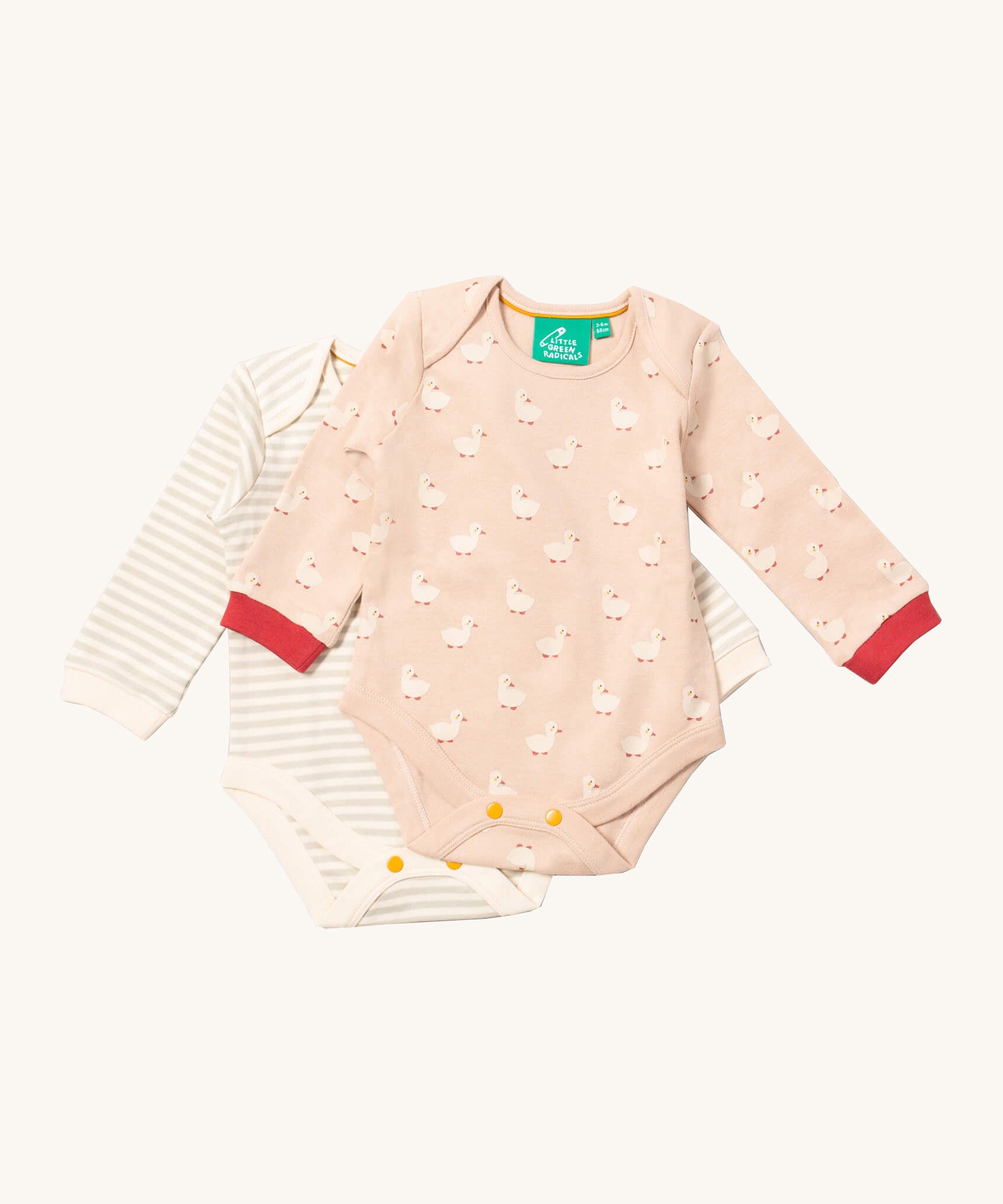 Little Green Radicals puddle ducks baby body suit 2 pack available at Babipur. A soft GOTS organic cotton bodysuit 2 pack in light pink with a cute duck print with red trim and a grey and cream striped bodysuit. Features yellow popper fastener around the crotch