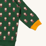 A close up of the Little Green Radicals brown owl raglan sweatshirt showing the yellow cuff detail and brown owl print on green organic cotton fabric.