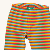 A close up of the Little Green Radicals rainbow striped organic leggings. Showing the elasticated detail and rainbow striped design on organic cotton fabric