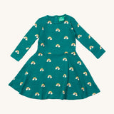 Little Green Radicals rainbow turquoise twirly dress available at Babipur. A GOTS organic cotton dress with long sleeves a popper fastener on the back. Features cute prints of rainbows on clouds.