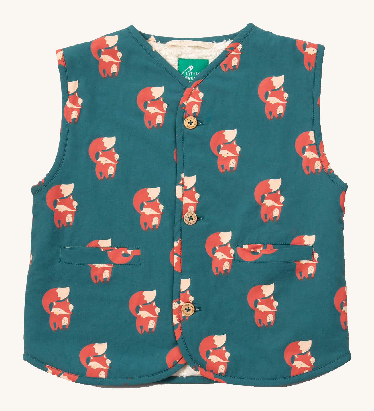 Little Green Radicals reversible gilet in red foxes and sherpa lined. A GOTS organic cotton gilet in teal with cute prints of foxes , 2 pouch pockets on the side and button fasteners. 