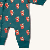 A close up of the Little Green Radicals sherpa line snow suit in red foxes. Showing the popper fastener detail and a close up of the red fox print on GOTS organic cotton fabric