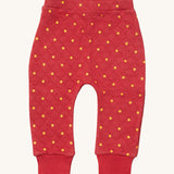 Little Green Radicals red star quilted joggers available at Babipur. A red GOTS organic cotton joggers with a quilted stitch with elasticated cuffs.