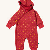 Little Green Radicals hooded snug suit in red stars. A GOTS organic cotton all in one suit in red. Features a full length zip thumb holes and yellow stars scattered all over