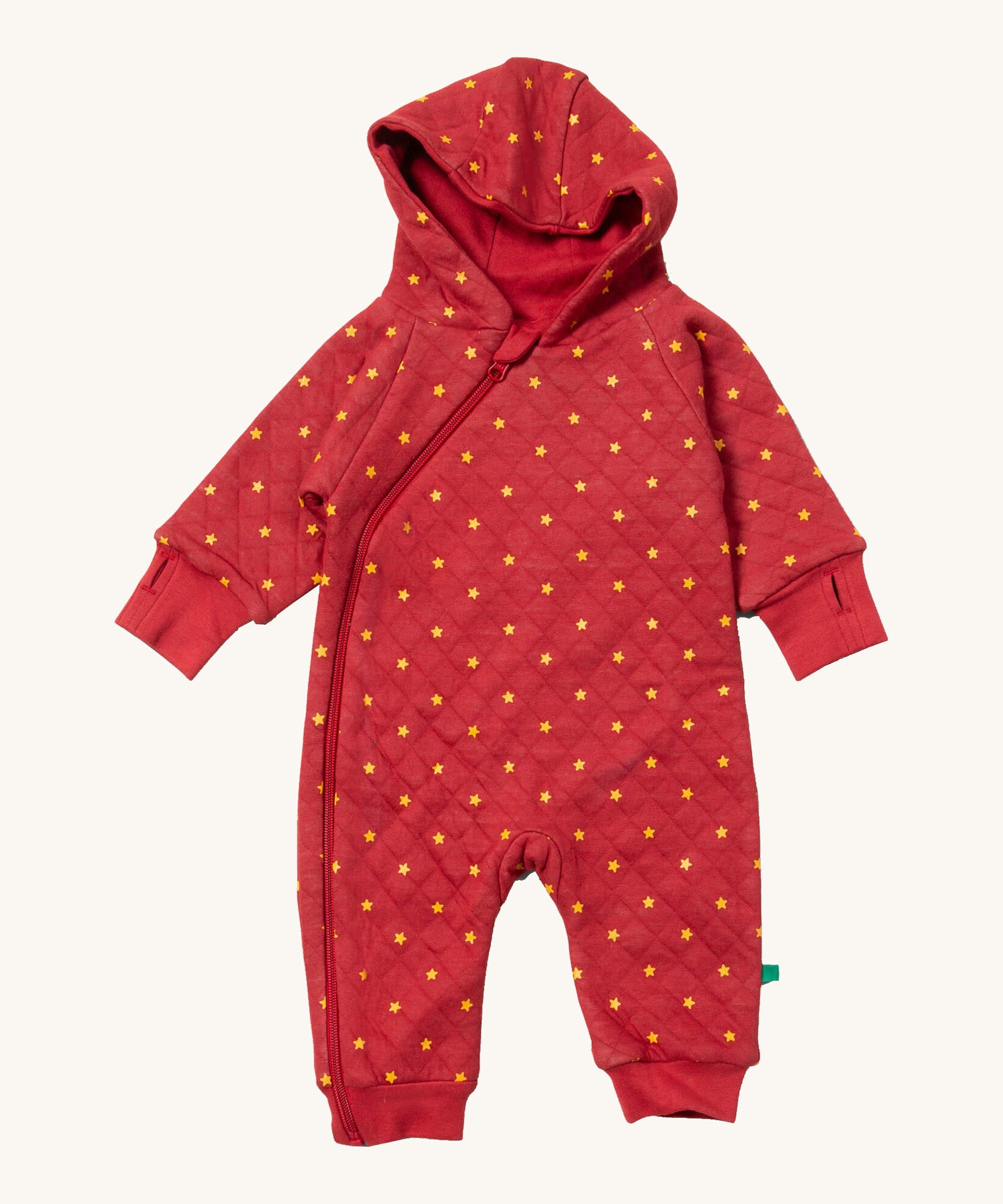 Little Green Radicals hooded snug suit in red stars. A GOTS organic cotton all in one suit in red. Features a full length zip thumb holes and yellow stars scattered all over