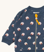A close up of the Little Green Radicals reversible easy rider jacket in sleeping sheep. Showing the zip detail which features a yellow toggle for easy opening and closing 