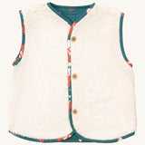 Little Green Radicals reversible gilet in red foxes and sherpa lined. A GOTS organic cotton gilet with a sherpa fleece style on the reversed side with the teal and fox prints trim. Features button fasteners for opening and closing. 