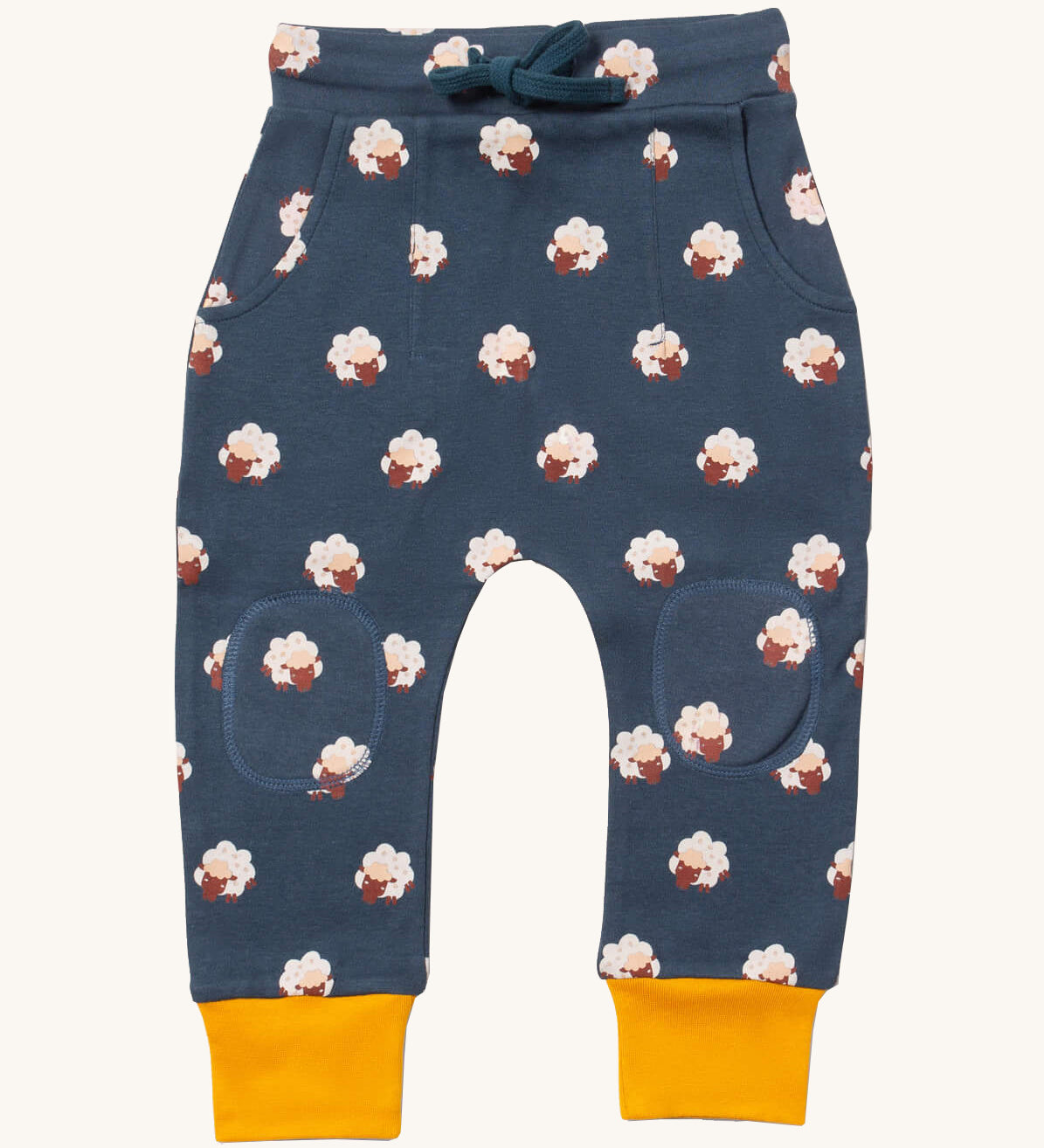 Little Green Radicals comfy joggers in sleeping sheep available at Babipur.. A soft GOTS organic cotton navy jogger pants with yellow trim. Features 2 side pockets a matching navy waist drawstring and knee patches.