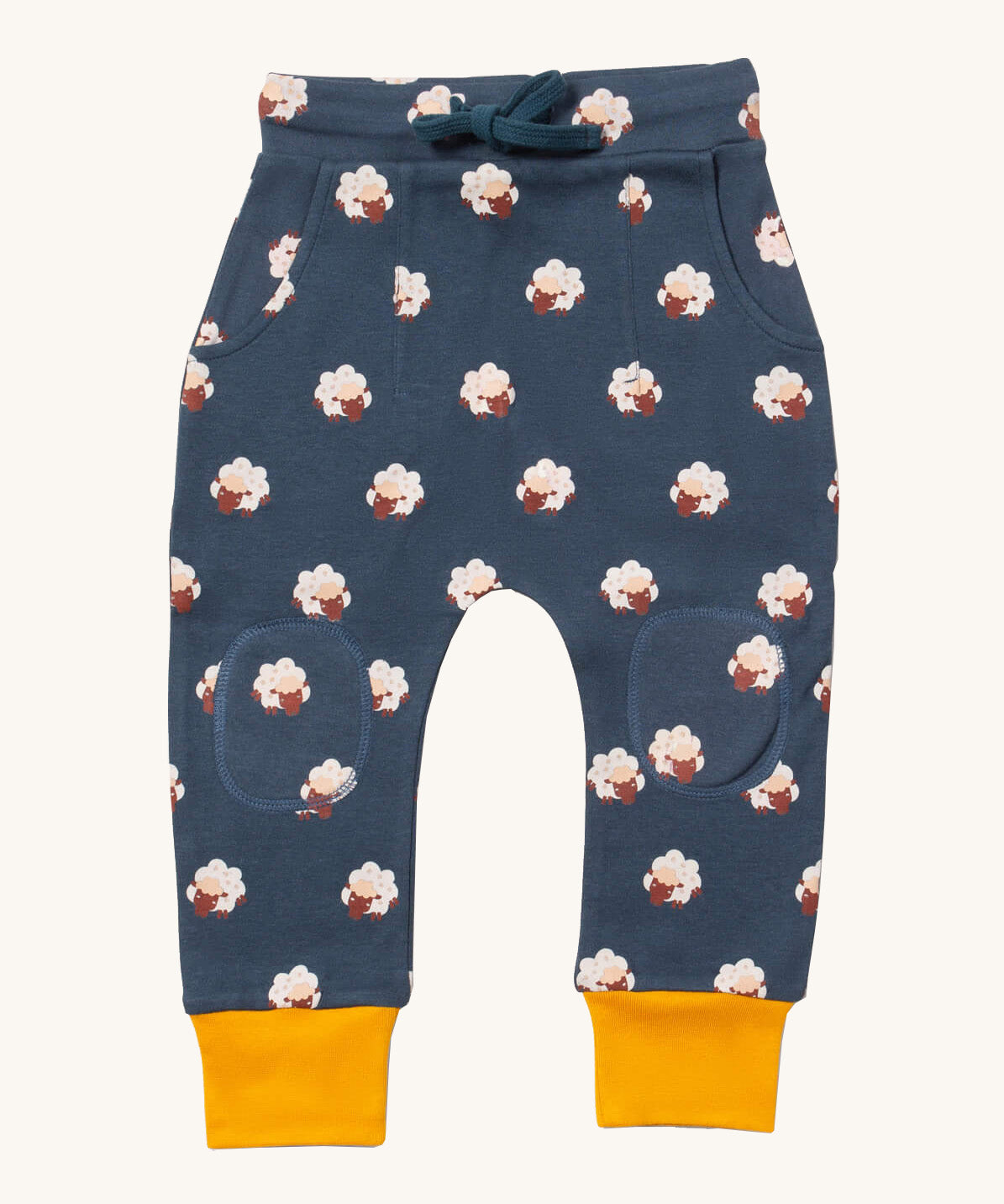Little Green Radicals comfy joggers in sleeping sheep available at Babipur.. A soft GOTS organic cotton navy jogger pants with yellow trim. Features 2 side pockets a matching navy waist drawstring and knee patches.