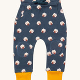 Little Green Radicals comfy joggers in sleeping sheep available at Babipur.. A soft GOTS organic cotton navy jogger pants with yellow trim. Features 2 side pockets a matching navy waist drawstring and knee patches.