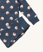 A close up of the Little Green Radicals sleeping sheep pyjama set showing the bottoms laid on top of the pyjama top