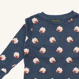 A close up of the Little Green Radicals sleeping sheep pyjama top showing the navy collar detail with a close up of the white sheep print on navy organic cotton fabric.