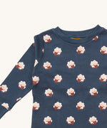 A close up of the Little Green Radicals sleeping sheep pyjama top showing the navy collar detail with a close up of the white sheep print on navy organic cotton fabric.