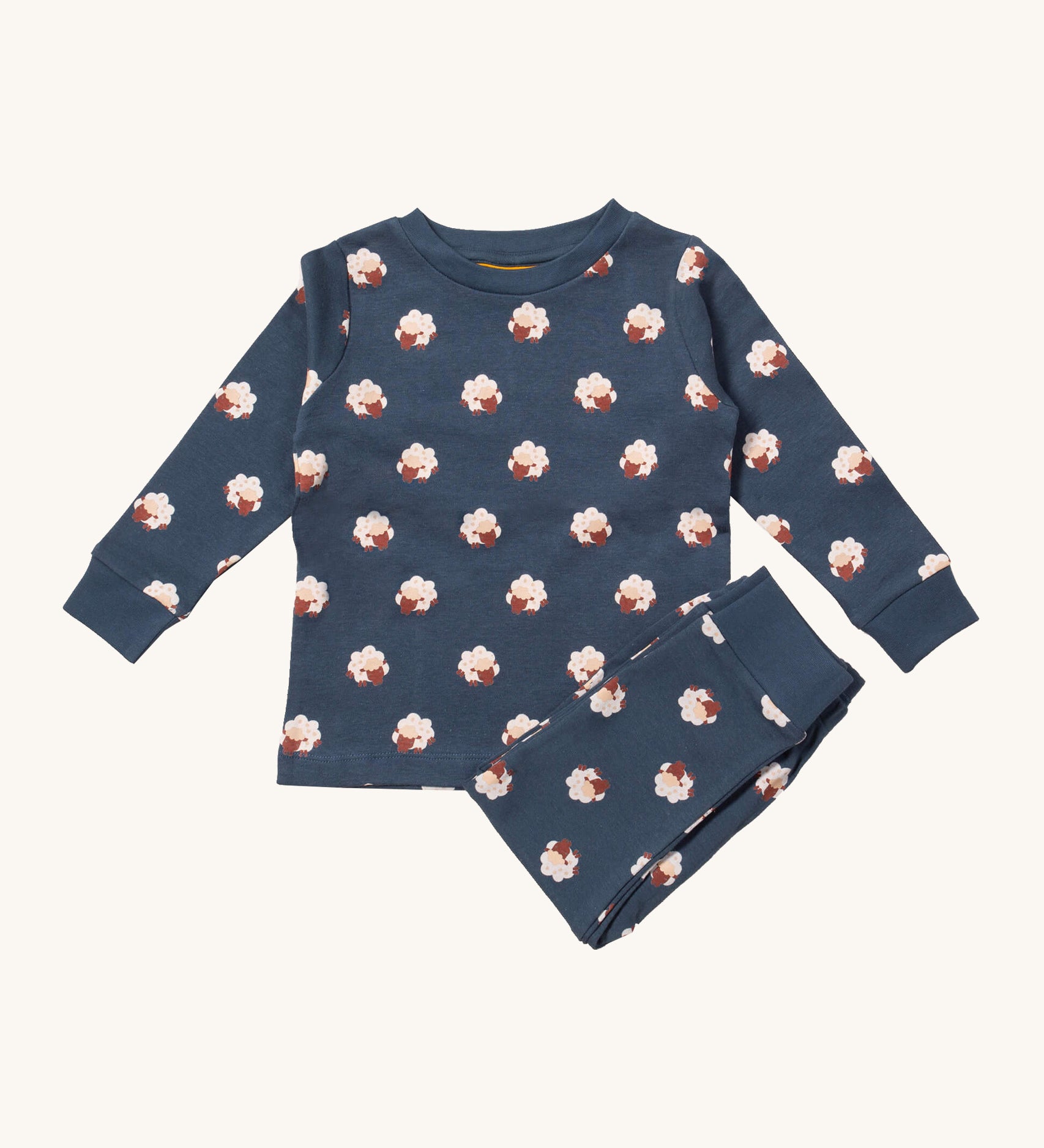 Little Green Radicals sleeping sheep pyjama set available at Babipur.. A GOTS organic cotton pyjama top and bottom set in navy blue with matching trim and prints of cute sheep