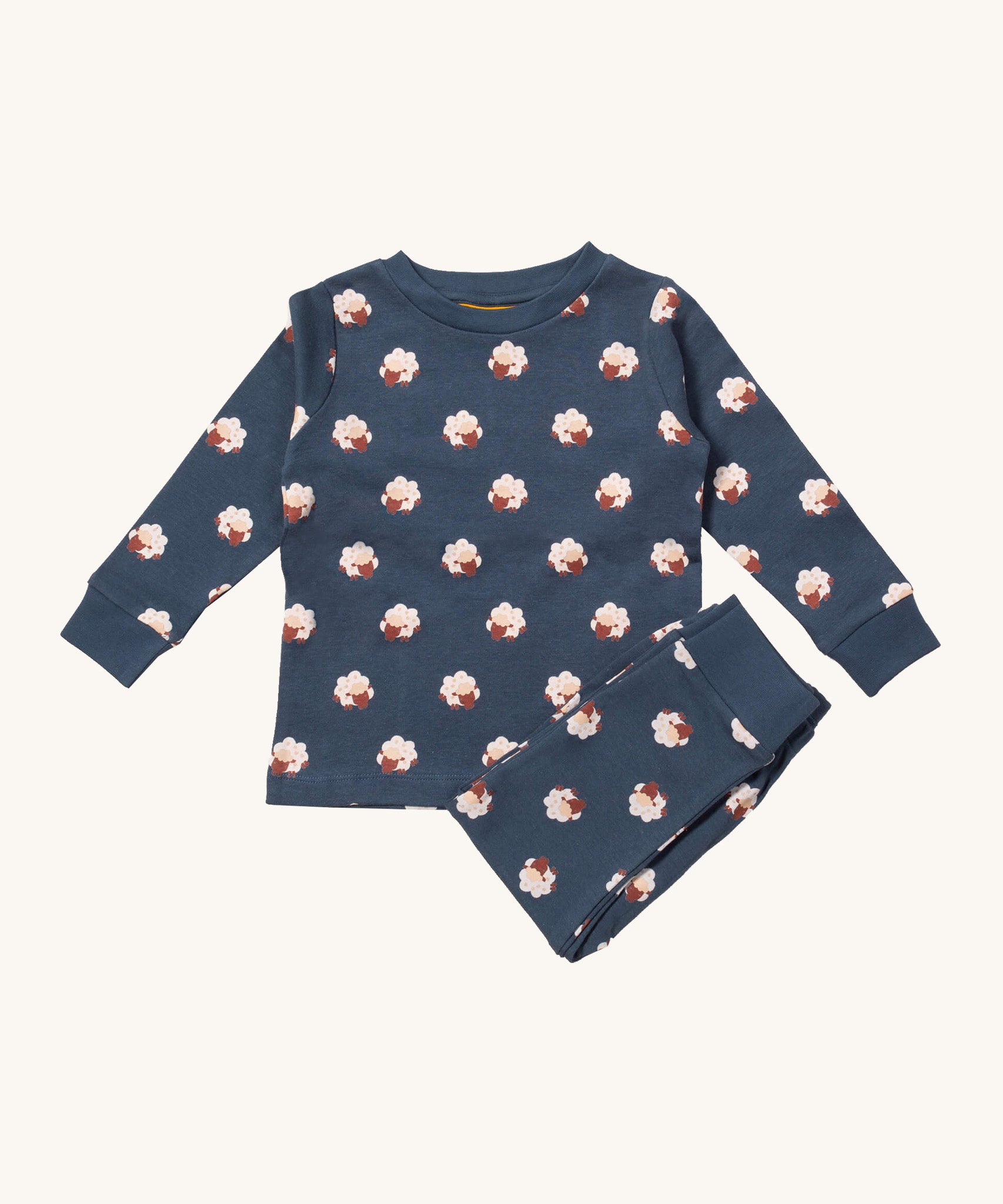 Little Green Radicals sleeping sheep pyjama set available at Babipur.. A GOTS organic cotton pyjama top and bottom set in navy blue with matching trim and prints of cute sheep