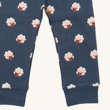 A close up of the Little Green Radicals sleeping sheep pyjama bottom. Showing the navy cuff detail with a close up of the white sheep print on navy organic cotton fabric.