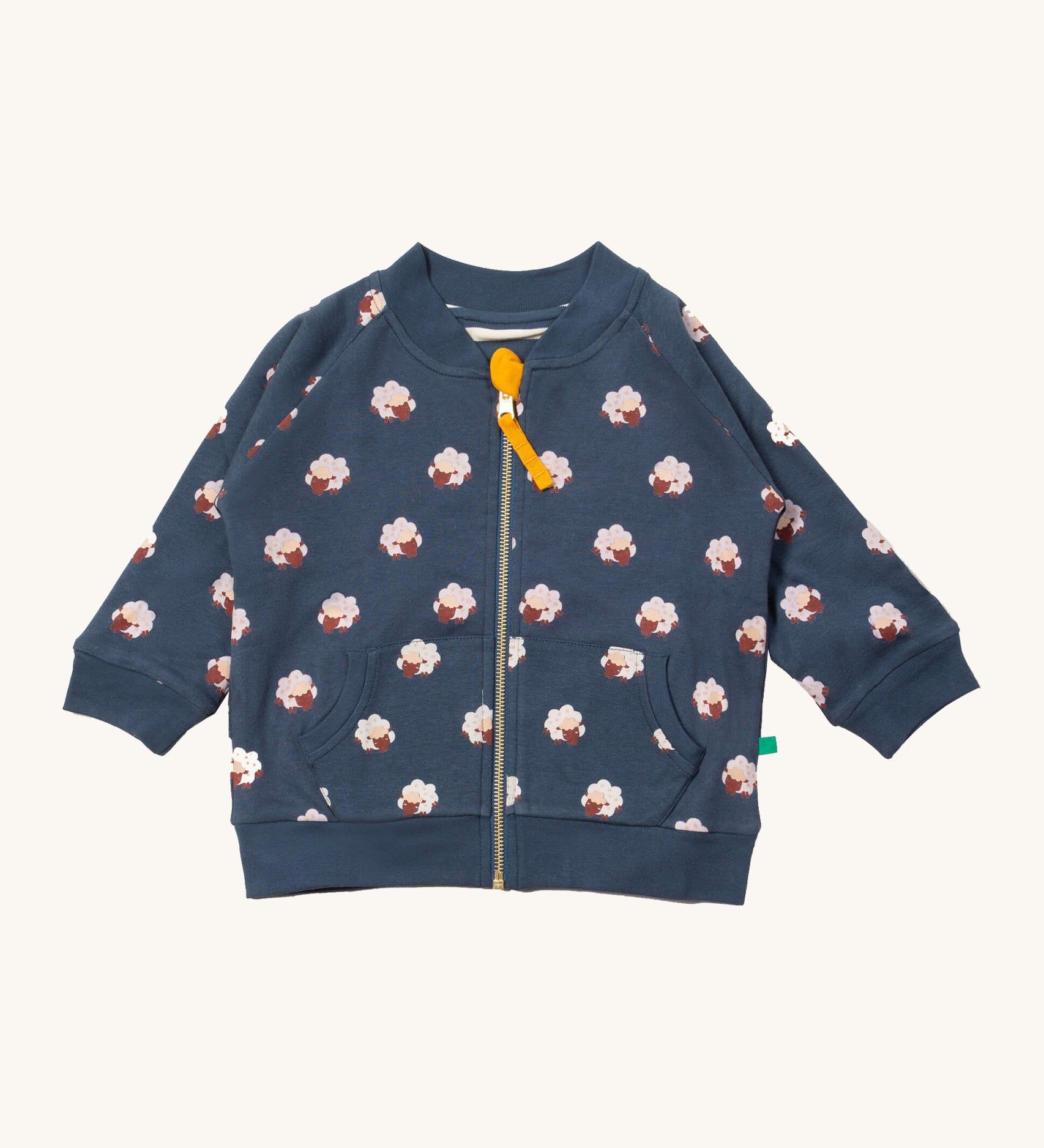 Little Green Radicals reversible easy rider jacket in sleeping sheep. A GOTS organic cotton bomber jacket style in navy with a full length zip, pouch pockets and cute prints of white sheep. 