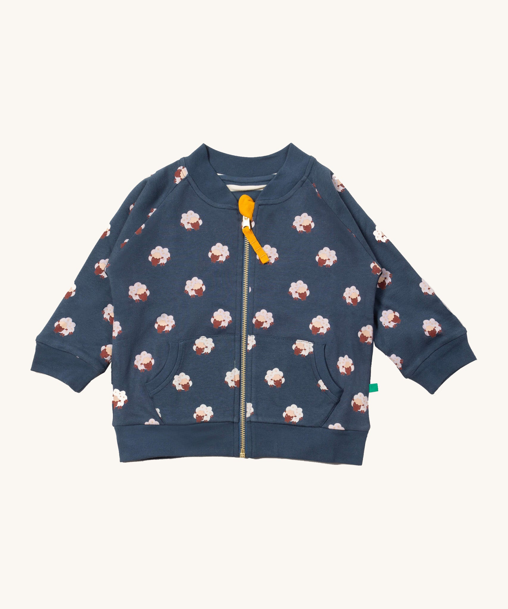 Little Green Radicals reversible easy rider jacket in sleeping sheep. A GOTS organic cotton bomber jacket style in navy with a full length zip, pouch pockets and cute prints of white sheep. 