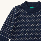 A close up of the Little Green Radicals navy sheep design showing the thick navy cuff and hem detail and a close up of the white speckles on navy organic cotton fabric
