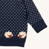 A close up of the Little Green Radicals navy sheep design showing the navy cuff and hem detail and a close up of the white speckles and sheep knitted in the jumper available at Babipur 