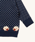 A close up of the Little Green Radicals navy sheep design showing the navy cuff and hem detail and a close up of the white speckles and sheep knitted in the jumper available at Babipur 