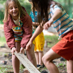  worn by a child playing with coloured fabric outside