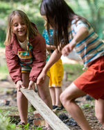 worn by a child playing with coloured fabric outside