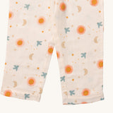 A close up of the Little Green Radicals classic pyjama bottoms from the sun and moon classic set. Showing the leg cuff detail and a close up of the starry night and flying blue birds print on light pink organic cotton fabric.