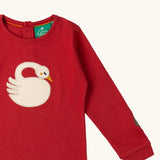 Close up of the applique on the front of the Little Green Radicals sleeping swan applique long sleeve organic cotton top in red.