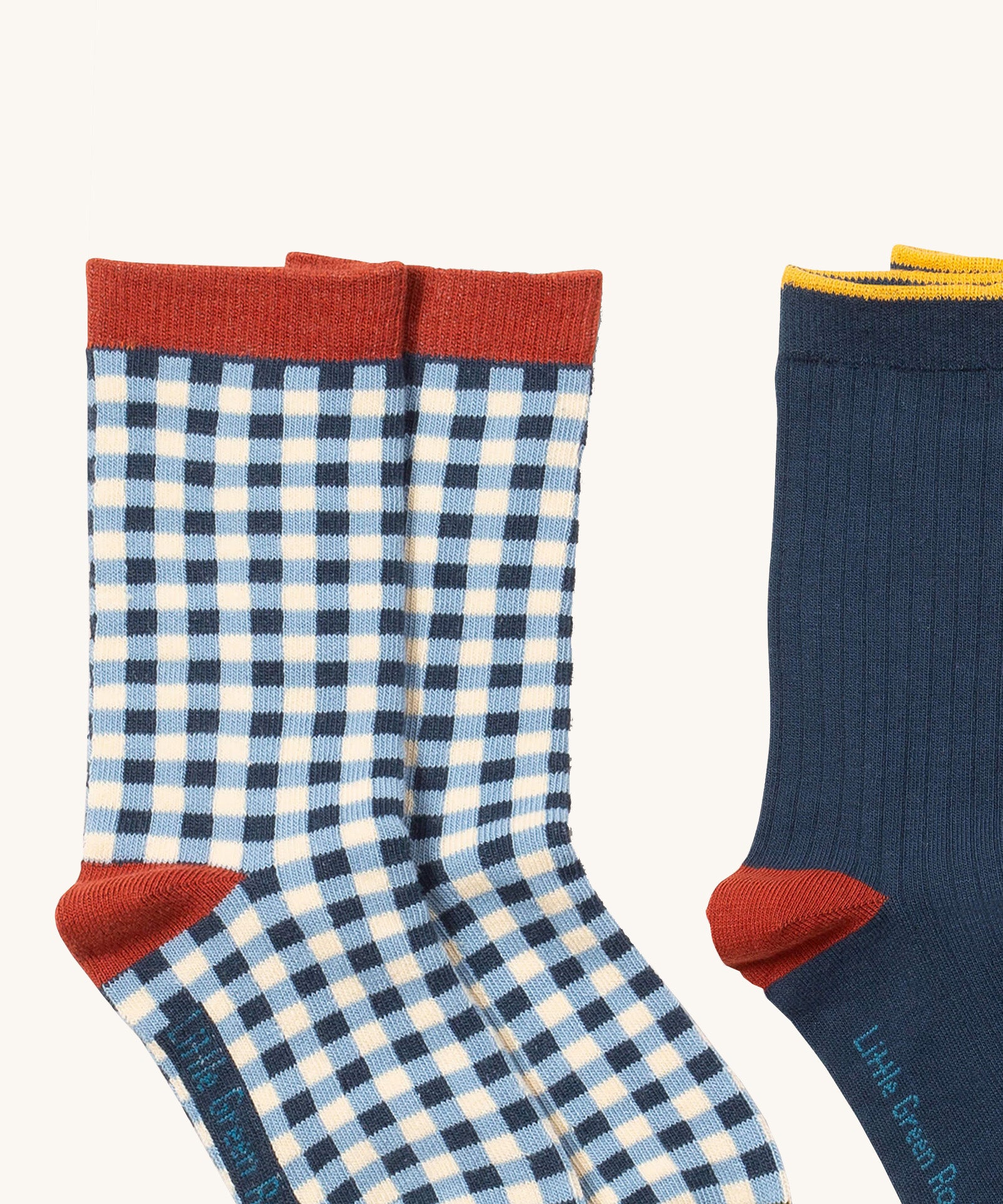 A close up of the blue and white check Little Green Radicals ankle socks showing check design with red trim detail on soft organic cotton fabric