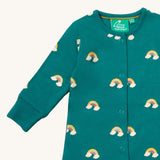 A close up of the Little Green Radicals turquoise rainbow baby grow, showing the popper fastener detail on turquoise organic cotton fabric.