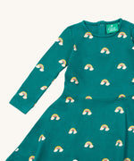 A close up of the Little Green Radicals rainbow turquoise twirly dress showing the long sleeve and popper detail
