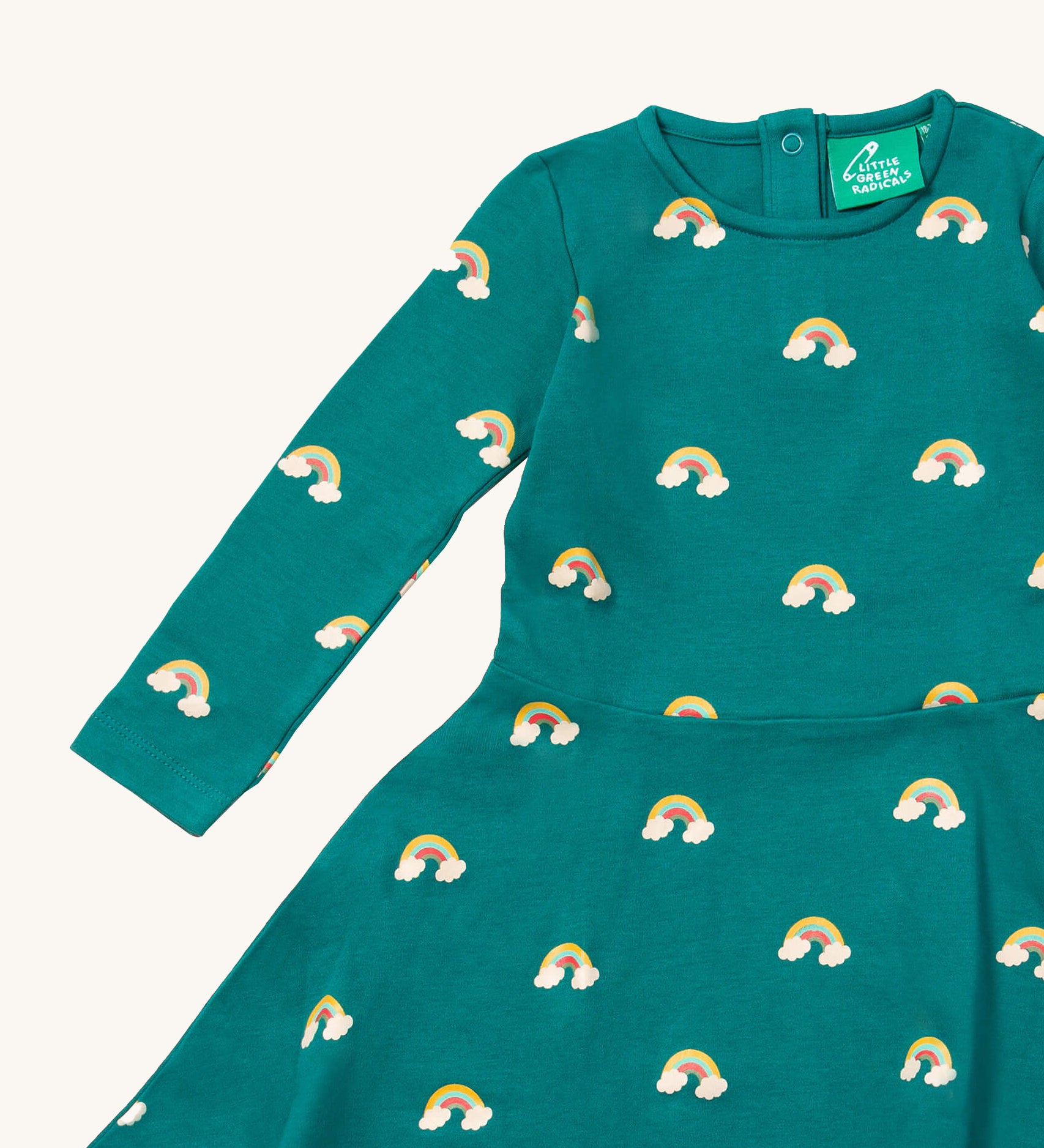 A close up of the Little Green Radicals rainbow turquoise twirly dress showing the long sleeve and popper detail
