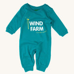 Little Green Radicals Wind Farm Organic Cotton Playsuit, in a light blue fabric, white lettering and a yellow wind turbine on a cream background