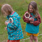  wearing the Little Green Radicals Garden Birds Recycled Waterproof Windbreaker Jacket