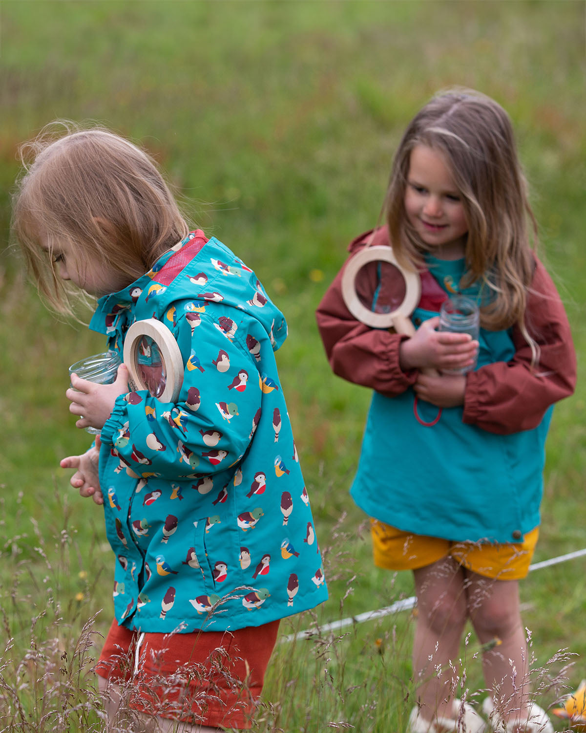  wearing the Little Green Radicals Garden Birds Recycled Waterproof Windbreaker Jacket