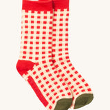 Little Green Radicals red and white check ankle socks from the winter rabbit set available at Babipur. A GOTS organic cotton sock with a check design with red and green trim.
