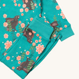 A close up of the Little Green Radicals winter rabbit pyjama set showing the bottoms laid on top of the pyjama top