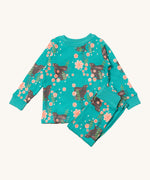 Little Green Radicals winter rabbits pyjama set available at Babipur.. A GOTS organic cotton pyjama top and bottom set in turquoise with matching trim and prints of rabbits in pink flowers
