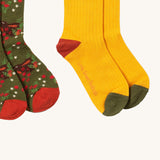 A close up of the yellow block Little Green Radicals ankle socks showing the red and green toe trim detail on soft ribbed organic cotton fabric
