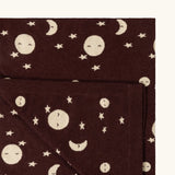 Close up of the Little Green Radicals brown moon knitted organic cotton baby blanket.