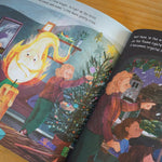 Pages of the Little Glow rhyming childrens book open on a wooden table