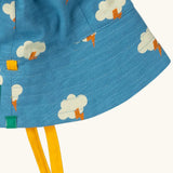 Close up of the Little Green Radicals all weather reversible children's organic cotton sunhat showing the yellow gold chin ties. 