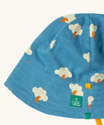 Close up of the Little Green Radicals all weather reversible children's organic cotton sunhat. Blue hat with all over cloud with lightning strike print. 