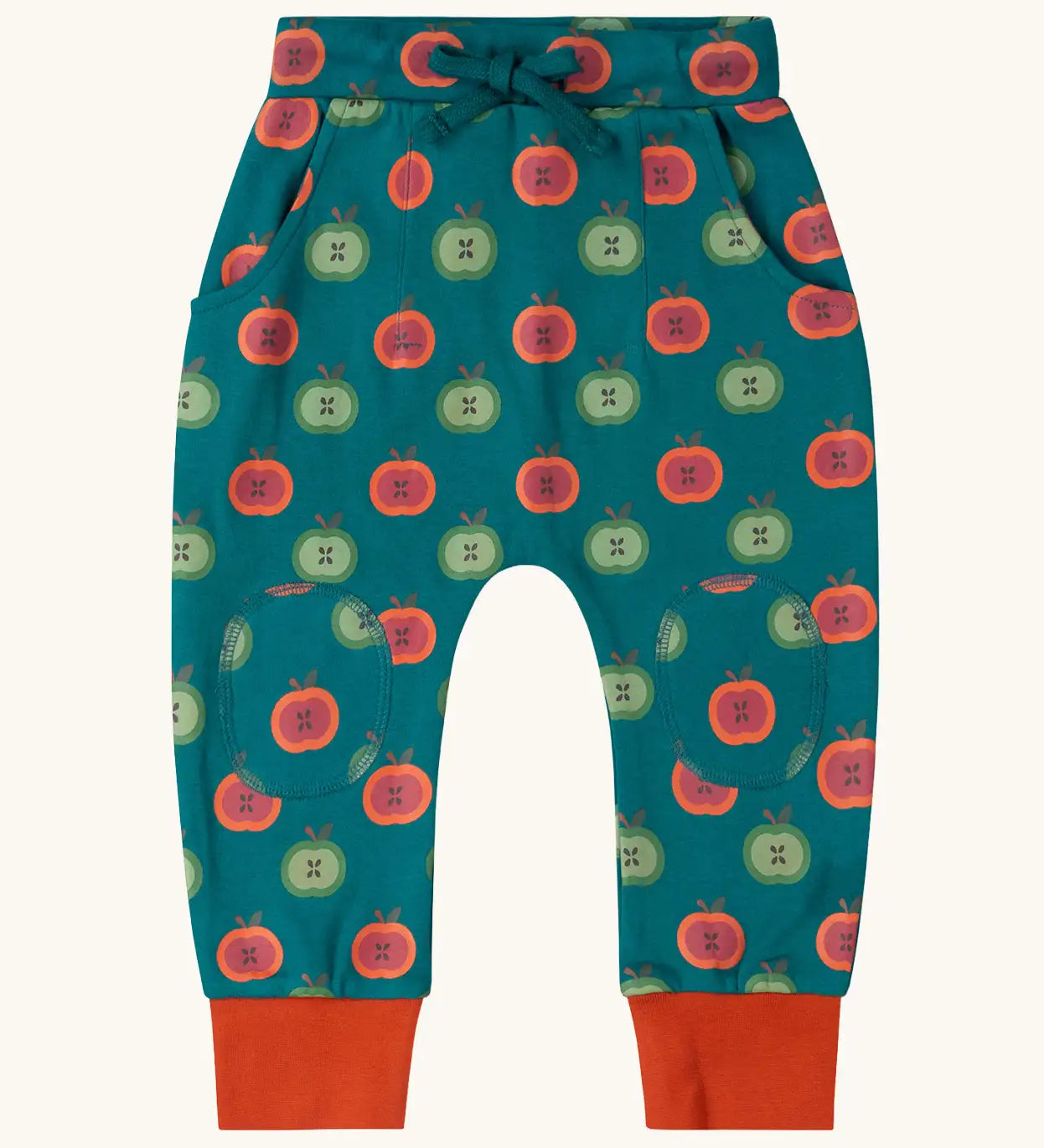 Little Green Radicals apple picking green comfy organic cotton joggers with red leg cuffs. Repeat green and red apple print on a dark green background. 
