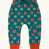 Little Green Radicals apple picking green comfy organic cotton joggers with red leg cuffs. Repeat green and red apple print on a dark green background. 