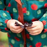 Close up of the elasticated arm cuffs on the Little Green Radicals apple picking recycled waterproof children's raincoat. 