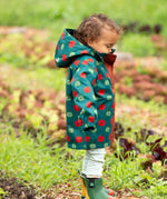 Side of a child wearing Little Green Radicals apple picking recycled waterproof children's raincoat.  