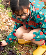 Close up of the zip on the front of the Little Green Radicals apple picking recycled waterproof children's raincoat with a child wearing it.